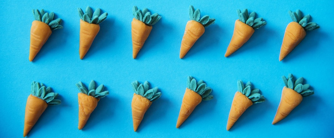 plastic carrots on a blue surface