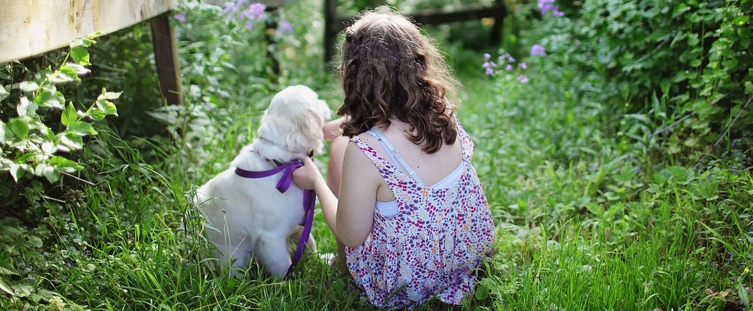 girl with her puppy outdoors