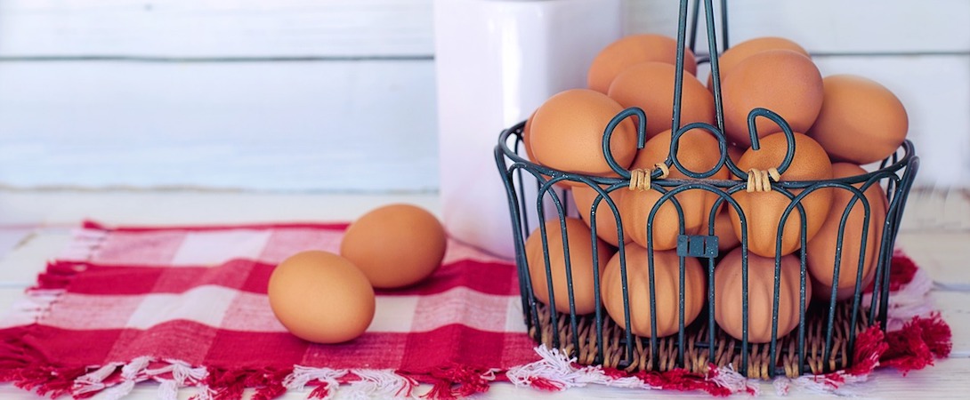 brown eggs in a basket on a red tablecloth