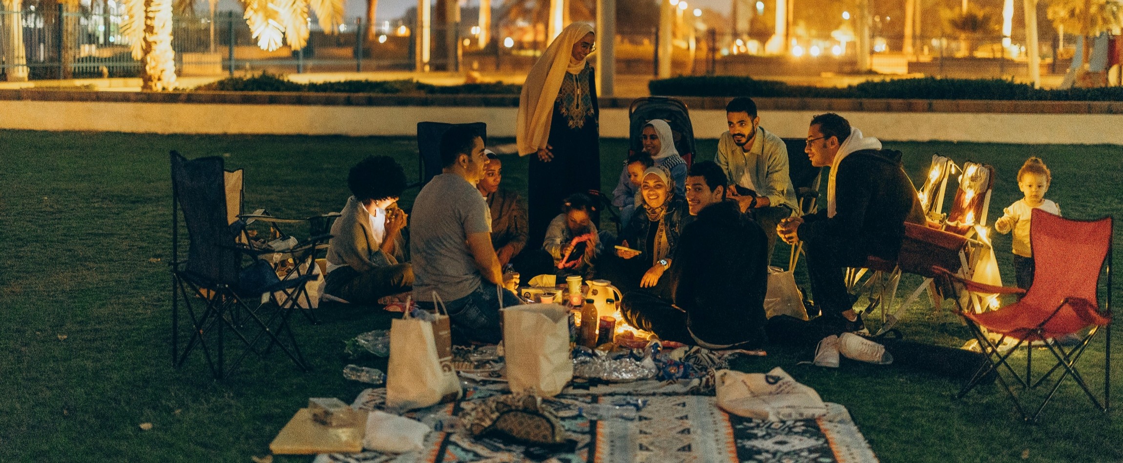 family having evening picnic in park Abu Dhabi United Arab Emirates