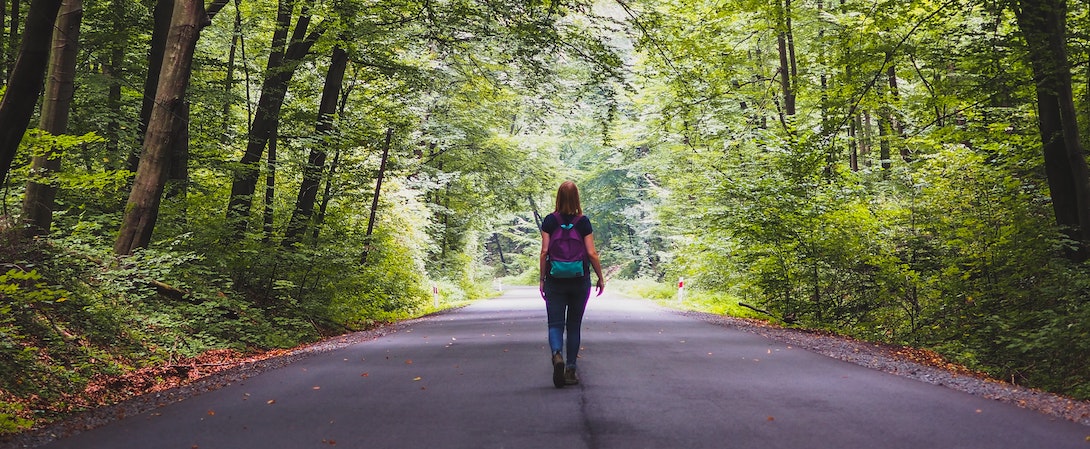 person walking on road
